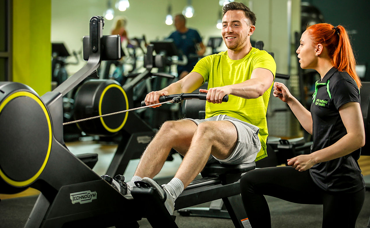 Man and woman receiving intruction for personal trainer